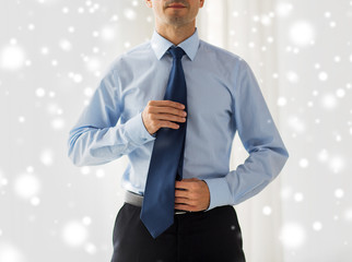 Sticker - close up of man in shirt adjusting tie on neck