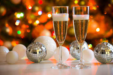 Two champagne glasses and christmas balls