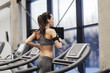 © Syda Productions - woman with earphones exercising on treadmill