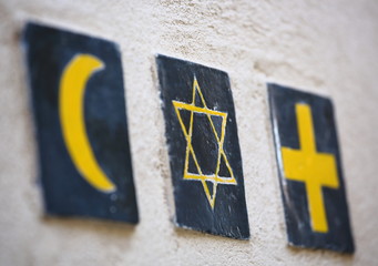 Set of 3 religious symbols: islamic crescent, jewish David's star, christian cross (wall sign on the street of Segovia, Spain) 