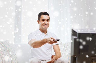 Sticker - smiling man with remote control watching tv