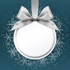 christmas ball with silver satin ribbon bow on blue background