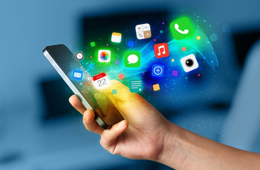 Poster - Hand holding smartphone with colorful app icons