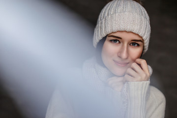 Wall Mural -  Woman in white sweater and winter hat.