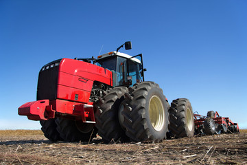 Poster - Red tractor working in the field