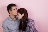 Fototapeta  - Close portrait of young pair with pink background