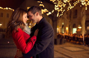 young happy attractive amorous couple embracing outdoors