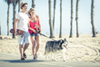 Young couple with husky dog in Santa monica