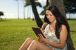 © blvdone - Young woman in Hawaii using tablet computer