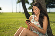 © blvdone - Young woman in Hawaii texting cell phone