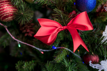 red ribbon bow on christmas tree