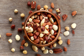 Wall Mural - mix nuts in wooden bowls on wooden table