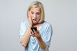 © michaelheim - Surprised woman looking at her mobile phone