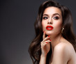 © opolja - Beauty Model Woman with Long Brown Wavy Hair. Healthy Hair and Beautiful Professional Makeup. Red Lips and Smoky Eyes Make up. Gorgeous Glamour Lady Portrait. Haircare, Skincare concept