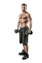 Powerful man with muscular build is training with the dumbbells.