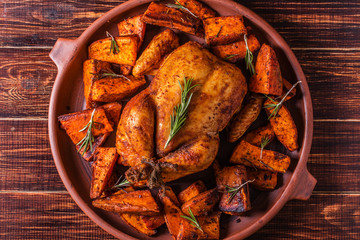 Wall Mural - homemade paprika and herb whole chicken with spices sweet potato