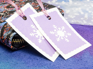 Christmas gift tags with wallet on blue background