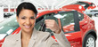© grinny - Car dealer woman with key.