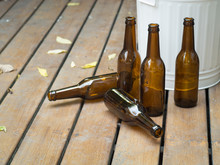 Bottles And Bin On Rustic Wooden Floor