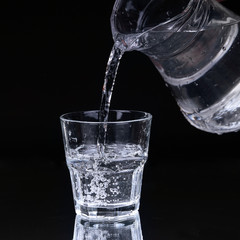 Wall Mural - Water pitcher pouring a glass of fresh water