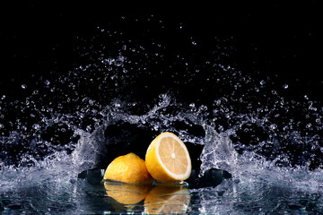 Sliced lemon in the water on black background