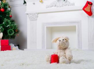 toy rabbit with a candle in Christmas Interior decoration with C