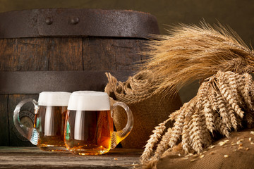 two beer glasses with wheat and barley