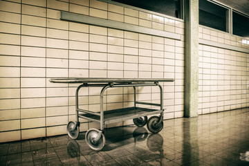 Old vintage metal stretcher in horror hospital