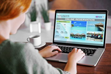 Woman using laptop to book hotel online