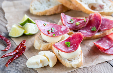 Wall Mural - Ciabatta sandwiches with fuet and mini cheese