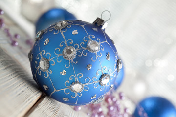 Sticker - Blue Christmas bauble on wooden background