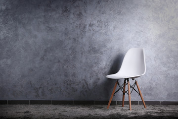 Stylish conception with one white chair on grey background