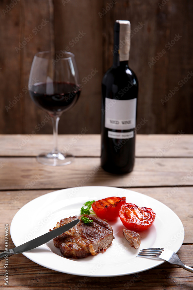 Roasted beef fillet on plate, on wooden background