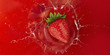 strawberry splash into red juice liquid