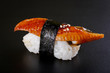 Nigiri sushi with eel on black background