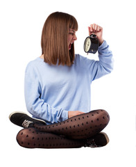 young woman desperate with an alarm clock on white