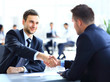 © ASDF - Two business colleagues shaking hands during meeting