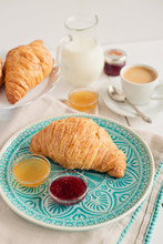 Romantic Breakfast With Croissant, Coffee, Milk, Honey And Jam On The Table