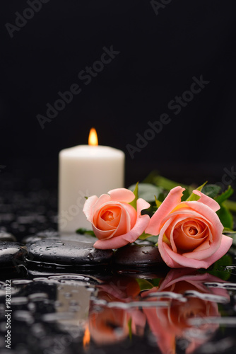 Fototapeta do kuchni Beautiful lying down orange rose with white candle and therapy stones 