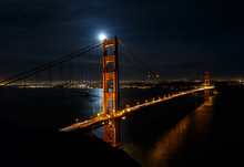 Full Moon Over The Golden Gate Bridge At Night With San Francisco Cityscape