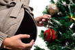 Pregnant decorates a Christmas tree