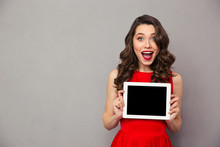 Woman In Red Dress Showig Blank Tablet Computer Screen