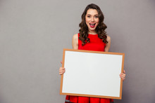 Cheerful Woman Holding Blank Board