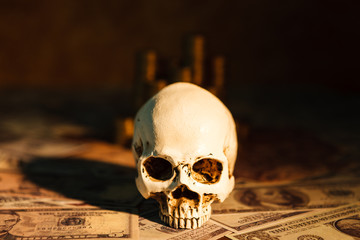 Capitalism concept : Skull on bank note, coin stack and vintage