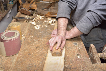 Wall Mural - carpenter working with plane on wooden