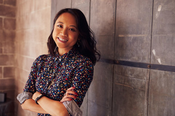 Portrait Of Female Designer Standing In Modern Office