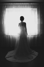 Silhouette Of Bride Looking Out The Window