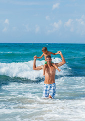 Wall Mural - Father and son playing in the sea