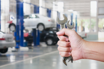 Hand of professional Auto mechanic with wrench