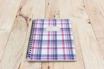 Wall Mural - Fabric plaid texture cover spiral notebook.